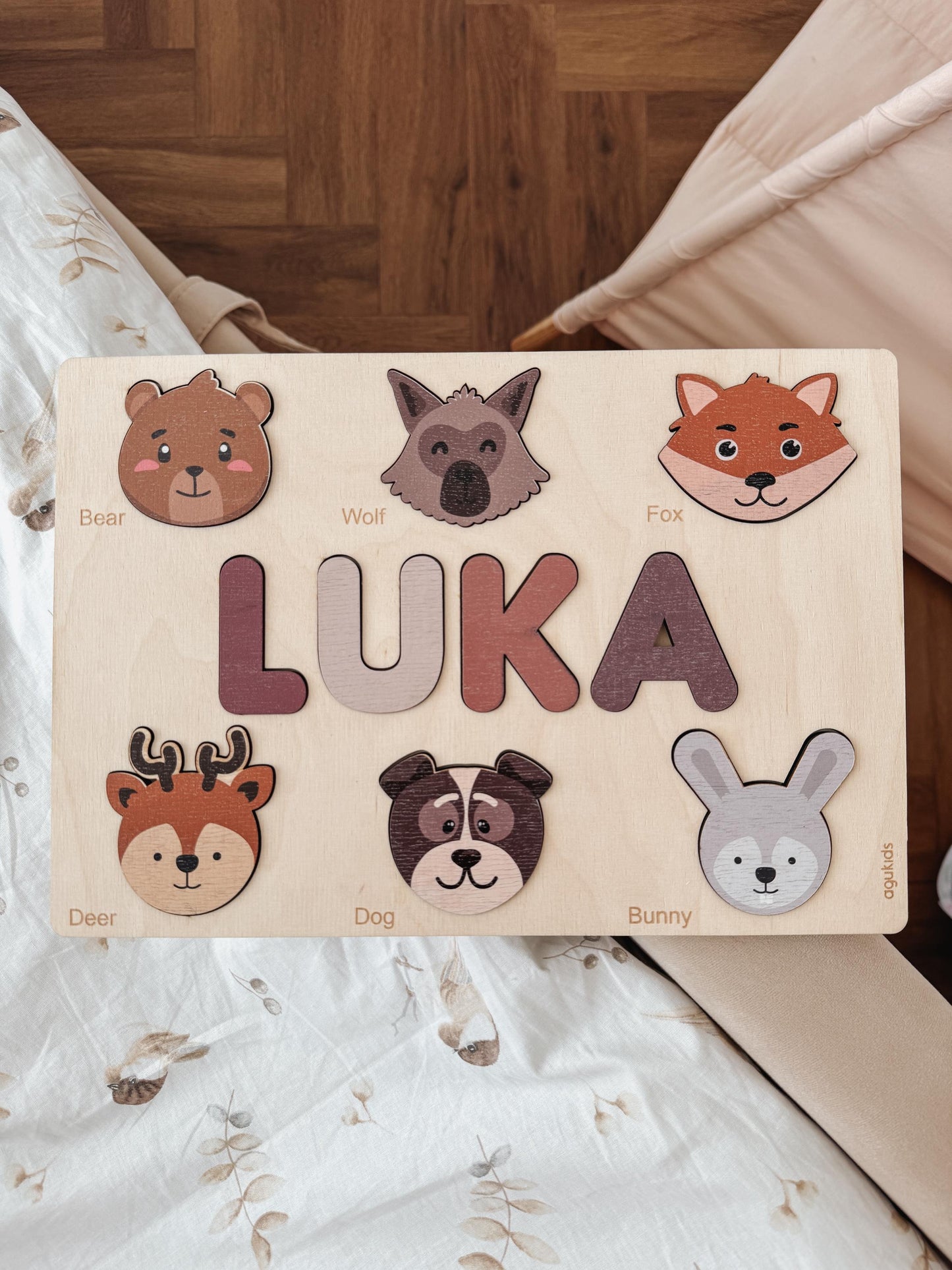 a wooden sign that says luka with animals on it