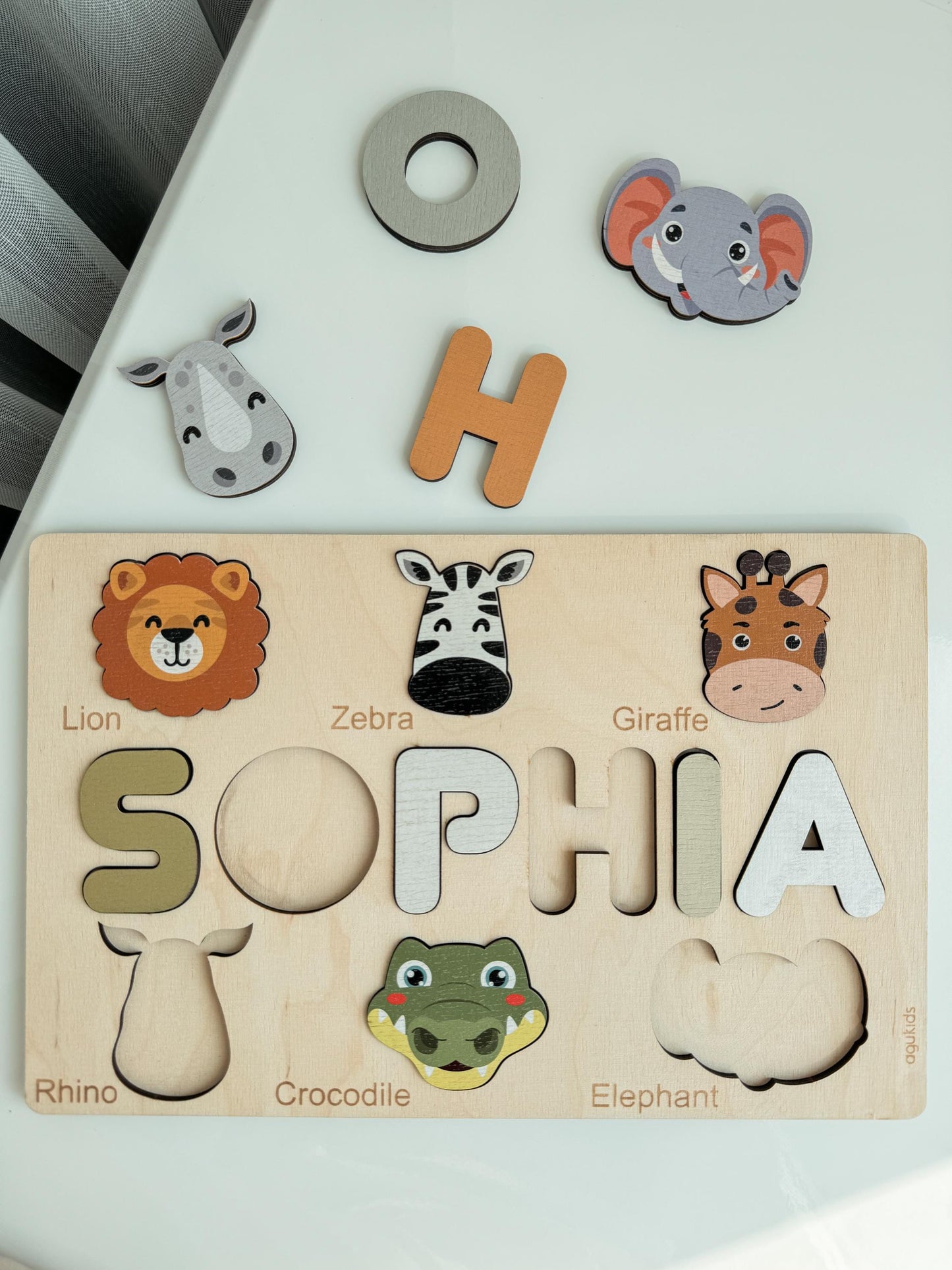 a wooden name puzzle with safari animals from Agukids brand