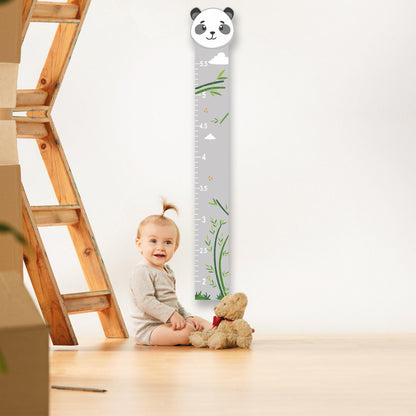 a baby sitting on the floor next to a Panda growth chart