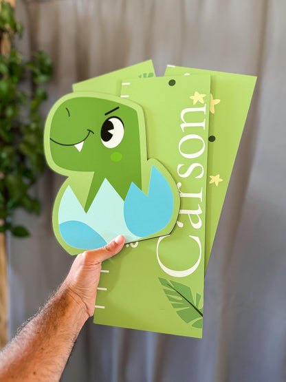 a person holding a green growth chart dinosaur on it